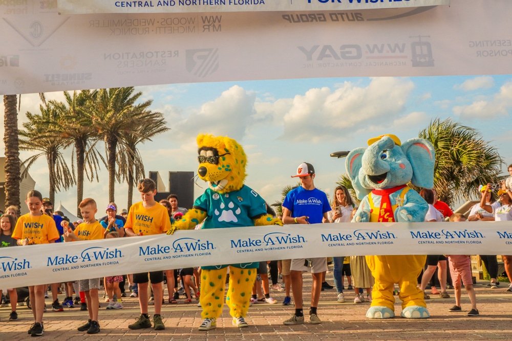 Jacksonville Jaguar mascot and crowd help cut the ribbon for the Jacksonville Walk For Wishes