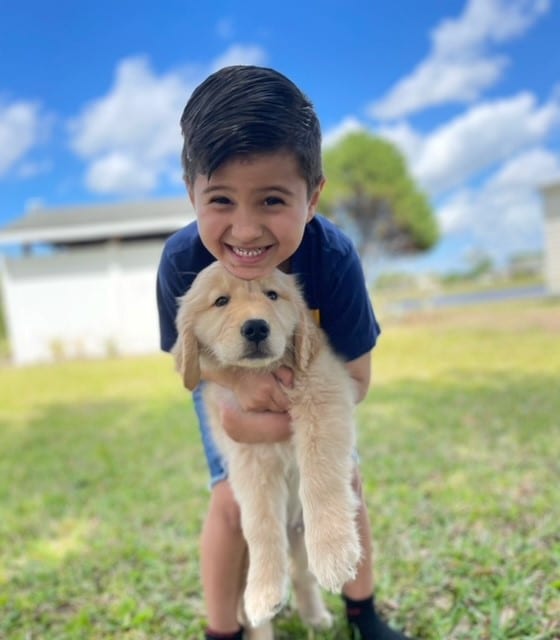 Wish Kid Jacob holding his new puppy
